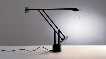 The Artemide Tzio Classic Table Lamp is available with a halogen or LED bulb and comes in 3 finishes.