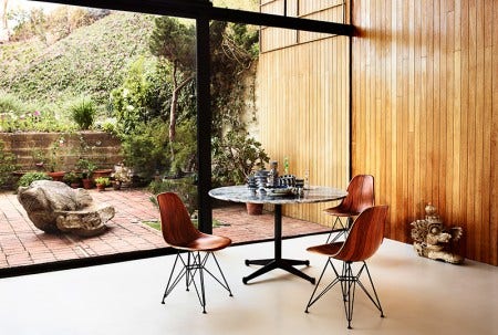Charles Eames famously said, "The role of the designer is that of a very good, thoughtful host anticipating the needs of his guests." With the molded, plastic, fiberglass, and wood shell chairs the Eames have created a universal response to what everyone wants from a chair: a simple, gracious form that fits any body and every place. This Eames Molded Wood Chair is available in 3 base options and walnut, ebony, white ash and Santos Palisander wood finishes.