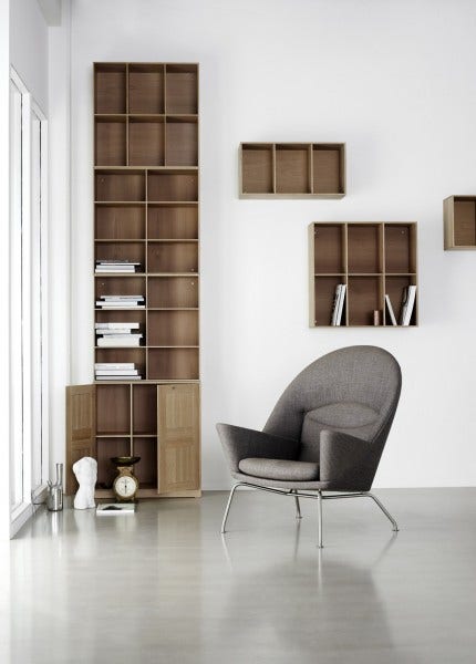 The Oculus Chair is available upholstered in leather or fabric and features stainless steel legs.