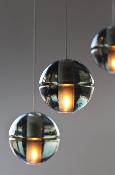 The Bocci 14 Series is a seamed cast glass sphere with a frosted cylindrical void that houses either a low voltage (12V, 10W xenon) or LED (12V, 1.5W) lamp. Individual pendants are visually quite subtle, but gain tremendous strength when multiplied and clustered in large groups.