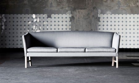 The Carl Hansen OW603 Sofa, designed by Ole Wanscher, is a Danish design classic redolent of both English and Oriental furniture. The sofas are handmade over a frame of beech and have upholstered, reversible cushions. Upholstered in fabric or leather and available as 2 or 3 seater.