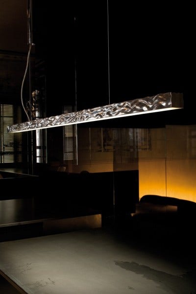 The FLOS Long and Hard Suspension light is the perfect solution for lighting over a dining table. Designed by Philippe Starck, 2005, it has a polished die-cast aluminum body and LED lights. 