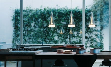 Designed by Achille Castiglioni, 1996, has hand blown glass conical diffusers with sandblasted edges. Available as 1, 3, 8 or 12 pendants. Great for over an island in the kitchen.