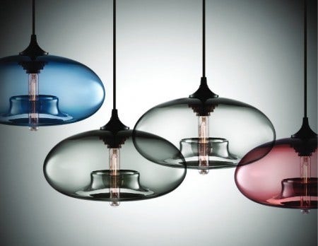 The Aurora Modern Pendant Light takes its name from the natural phenomenon sometimes seen in the northern skies when charged particles perform a dance of light as they enter the earth's magnetic field. Its hand blown glass curves represent the roundness of the earth's horizon line with an inspiring glow of warm light running through the center.