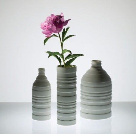 The Niche Groove Vases are a fresh take on traditional forms. They are not only a pleasure to hold but playful, with undulating lines and subtle rhythms. These vases have an unglazed exterior with a glazed interior. They are available as a small bottle, a large bottle, a vase, or as a set of three.