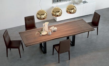 The Cattelan Sigma Drive Table has a walnut top and a "live edge" finish along the sides. It is extendable so you can invite everyone!