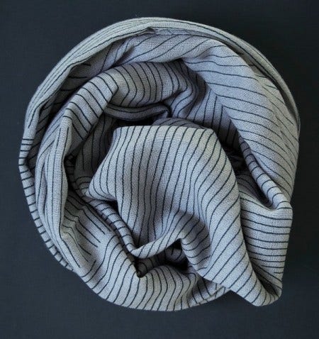 The Menu Printed Cashmere Scarf has a geometric pattern that is hand-printed on a super-soft, fine-gauge cashmere-wool blend, available in light grey and light blue tones.