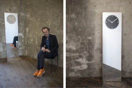 Designed in 2015 by one of the Netherlands' most successful designers, Richard Hutten, the Inverse Mirror Clock is multi-functional. A 70 inch mirror holds the clock face which, by turning the dial, the 12 positions of the clock can be changed. A clever feature that gives you the possibility to hang the clock horizontally or vertically or let it lean casually against a wall. The warmth of the solid oak stands in contrast to the cold appearance of the mirror, making this object suitable for any space.