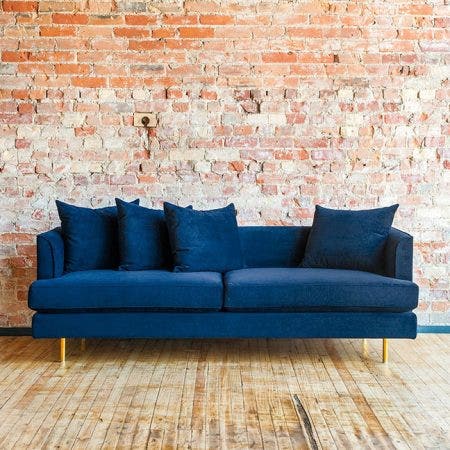 The Margot Sofa epitomizes modern elegance with graceful arms, French-seam detailing, and loose, luxurious cushions that give a look which is both timeless and contemporary. Every sofa includes two sets of cylindrical steel legs, allowing you to choose between a brass or black finish to suit your style. The seat and back cushions use a unique, eco-friendly synthetic-down, derived from recycled PET plastic.