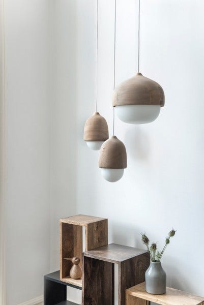 In Finnish Terho means acorn and the name refer to the natural and sympathetic shapes of acorns found in nature. The special color of alder wood and the opal made of white mouth blown glass is a unique combination of glass and wood only seen in lamps designs on rare occasions. The Terho lamps can be used individually or as a combination of different sizes in a small group.