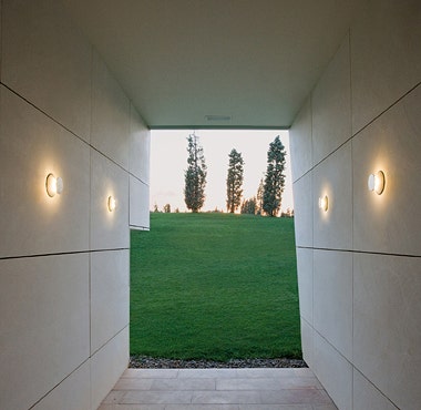 The Vibia Micro Outdoor Wall Lamp is a compact surface-mounted wall light for indoor and outdoor use. It gives good general indirect ambient light that washing over wall surfaces.