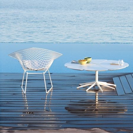 The Knoll Petal Table was designed by Richard Schultz in 1960. He cites Queen Anne’s Lace as his inspiration for this delicate outdoor table with its flower-like top sprouting from the elegant pedestal base. Each  "petal" expands and contracts independently, ensuring stability in changing weather.